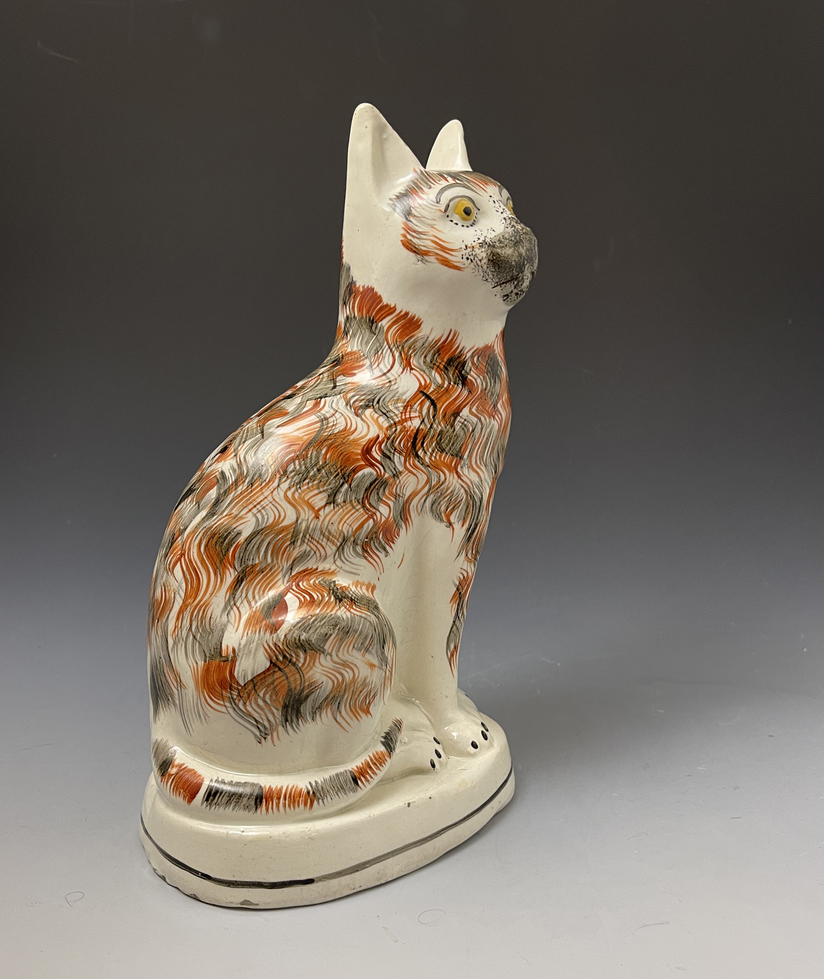 Staffordshire pottery large figure of a seated cat with a fiery