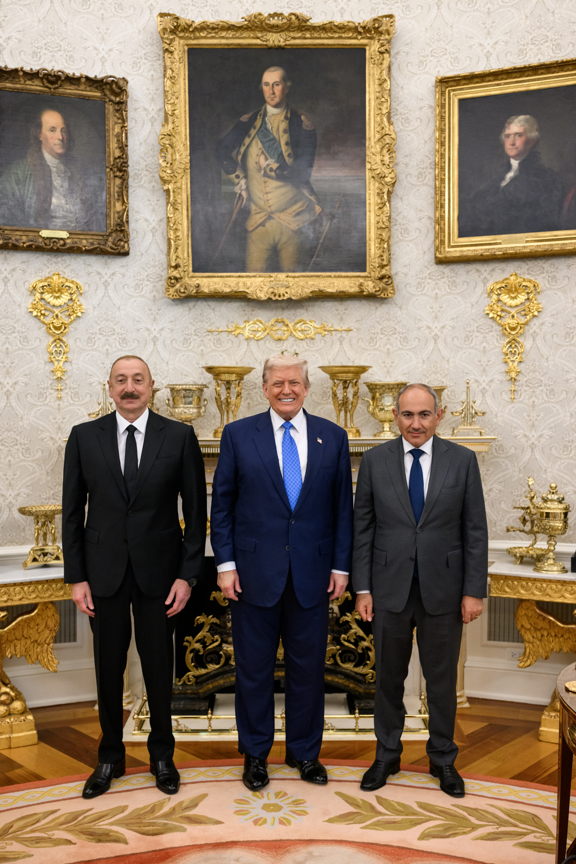 President Donald Trump signs a trilateral joint declaration with