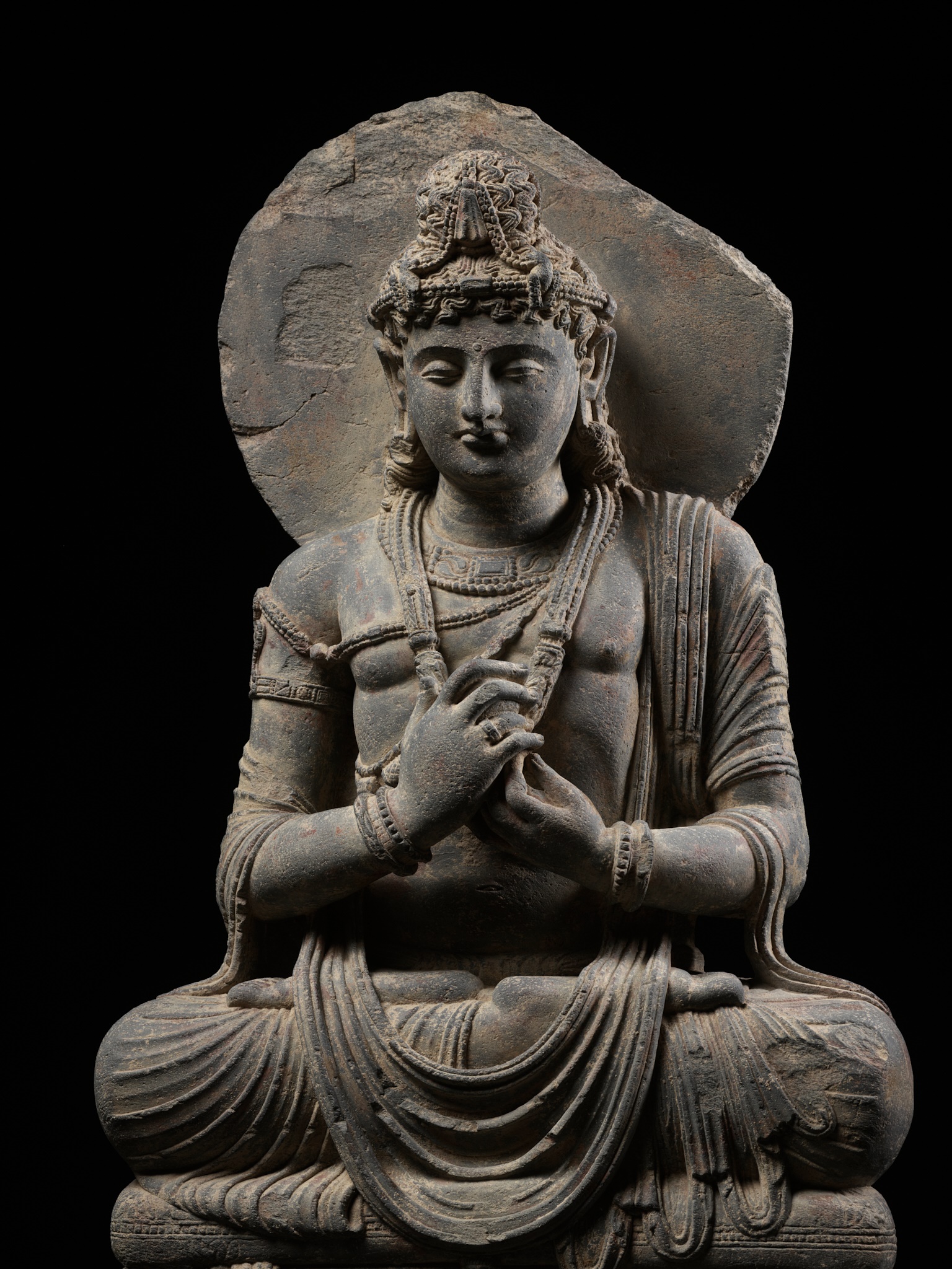 Lot 230 - A LARGE GRAY SCHIST FIGURE OF MAITREYA,