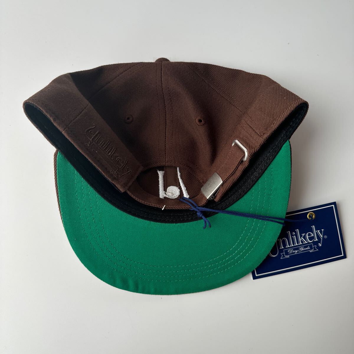 即完売 Unlikely×NEPENTHES NEW YORK CAP ブラウン アンライクリー