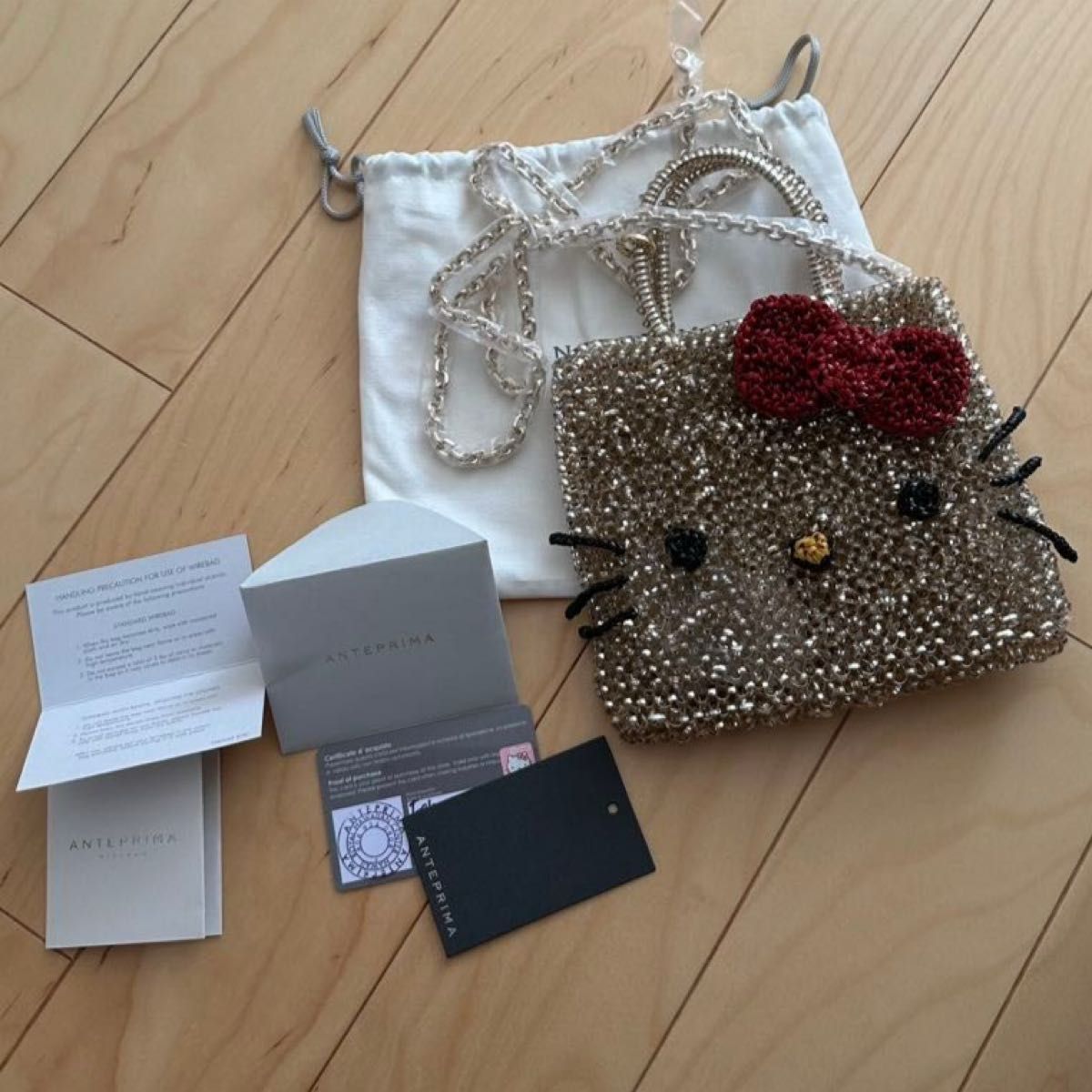 アンテプリマ ハローキティ ワイヤーバッグ ゴールド 日焼けキティ