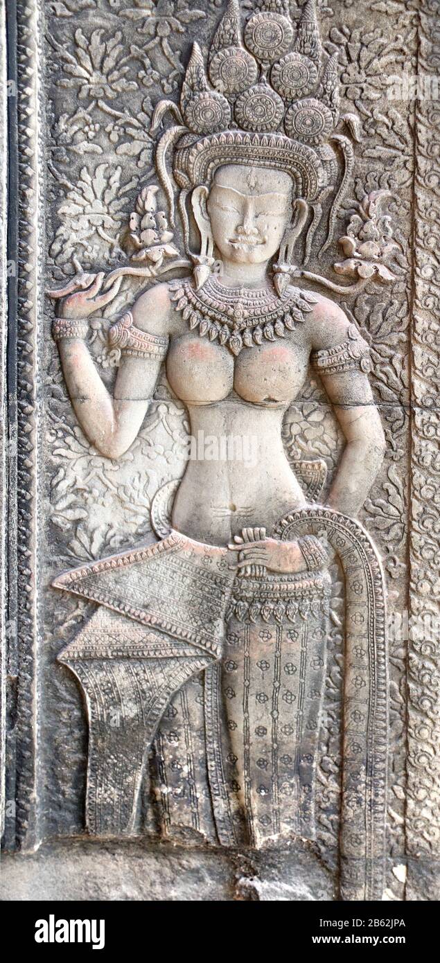 Wall carving with woman - dancer apsara, famous Angkor Wat complex