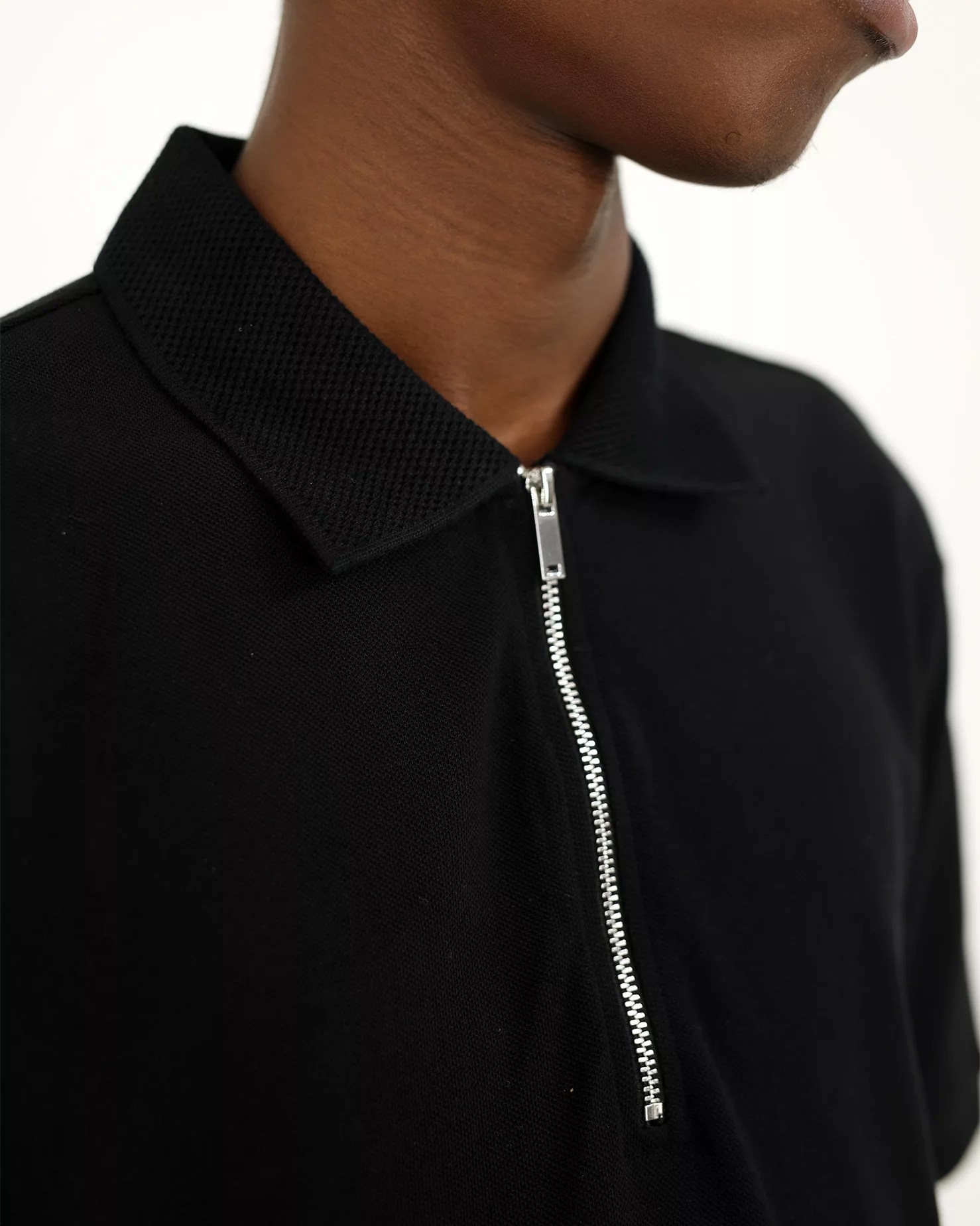 Buy the Garmspot Zip Polo Shirt in Black on Garmspot.com