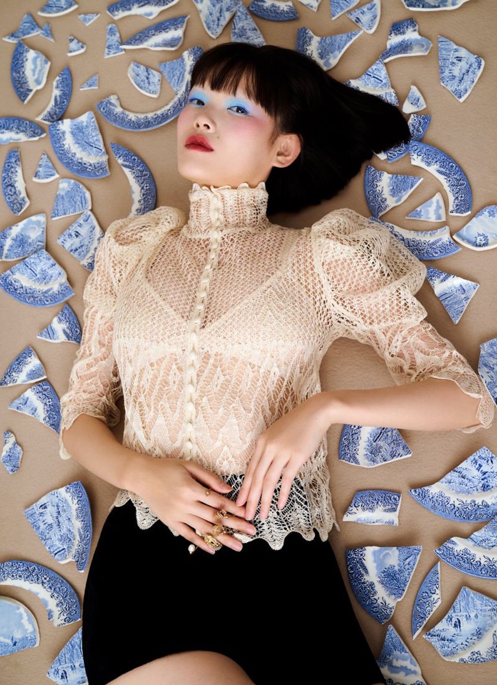 Dior Churns An Apple on Her Head, A Sharp Pencil at her Throat