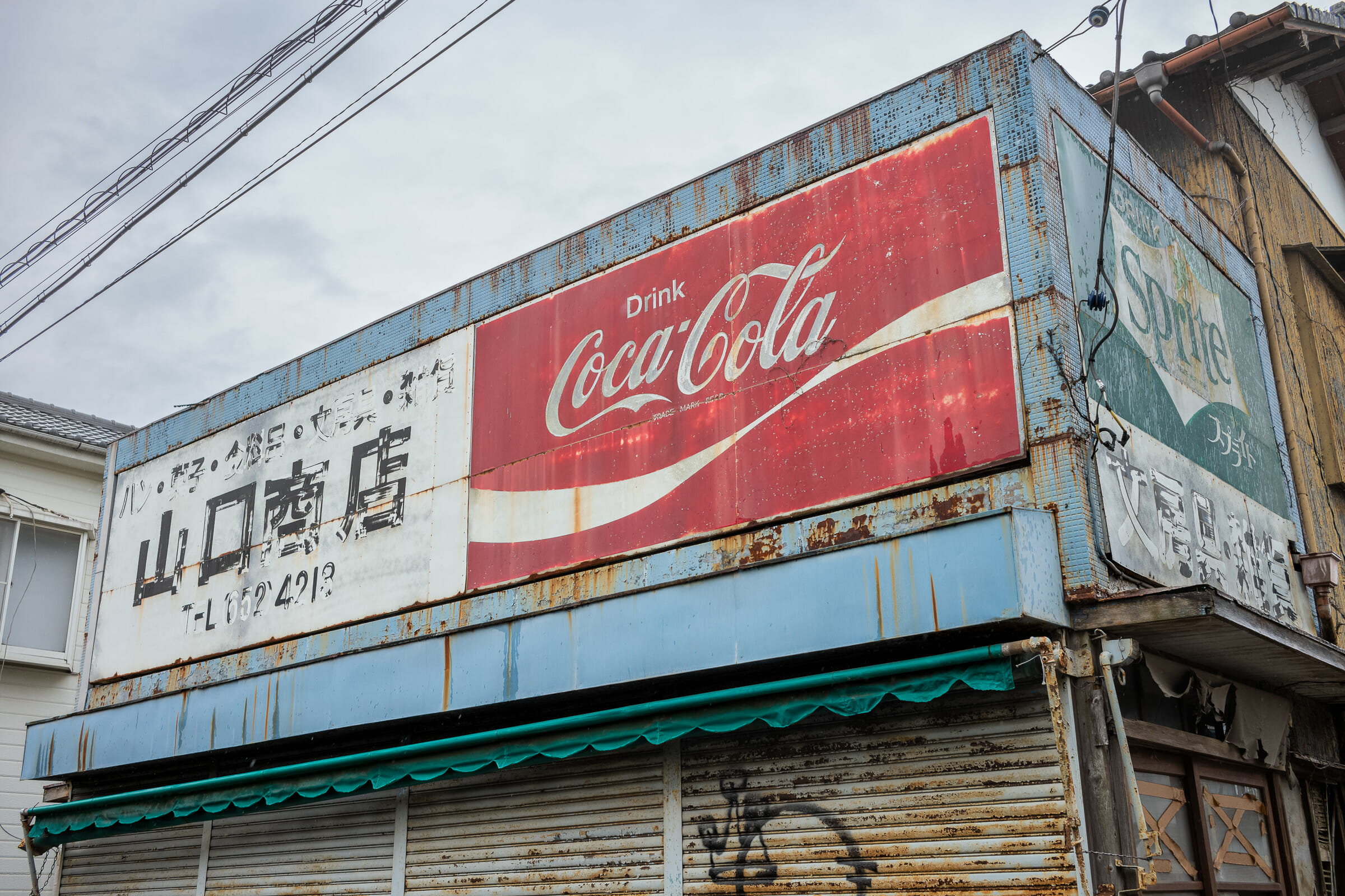 A dilapidated Tokyo shop and its wonderfully faded Coca-Cola and