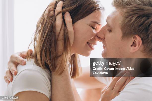 Closeup Of A Couple Of Lovers Kissing On A White Background High