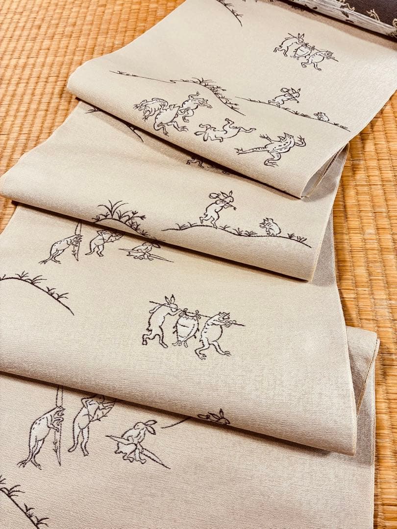 素敵な装い！西陣名古屋帯 綿芯仕立付 「鳥獣人物戯画」クリーム